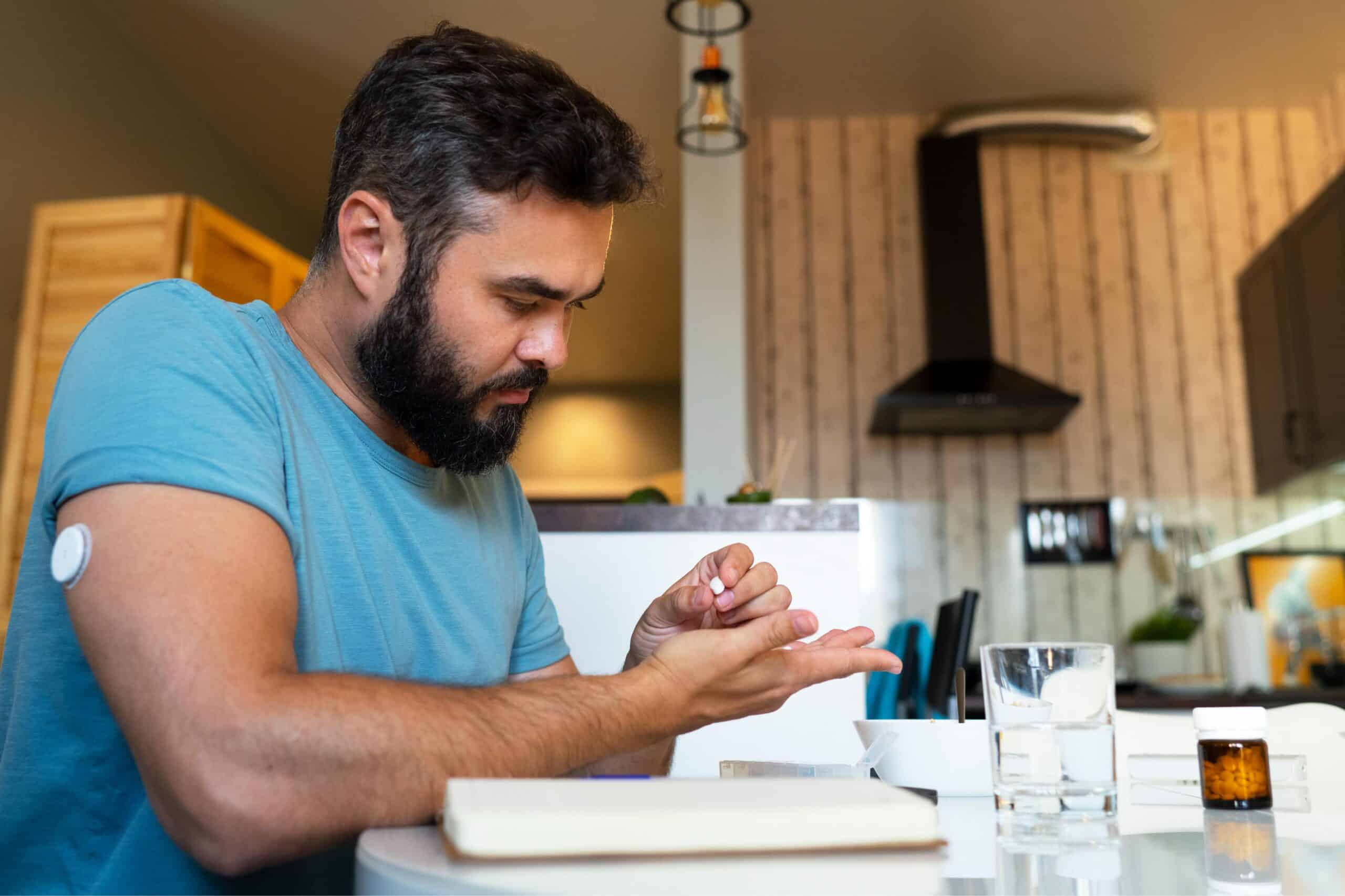 diabetic man checking glucose patch sensor scaled