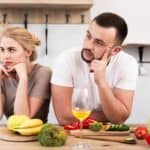 young couple thinking kitchen